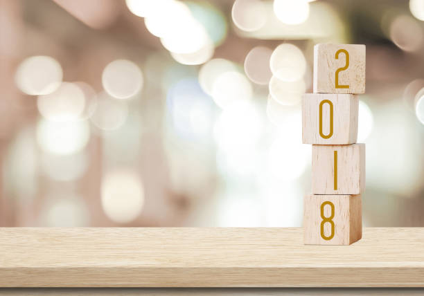 istock Wooden cubes with 2018 on perspective wood over blur bokeh background with copy space for text, new year template 680337604