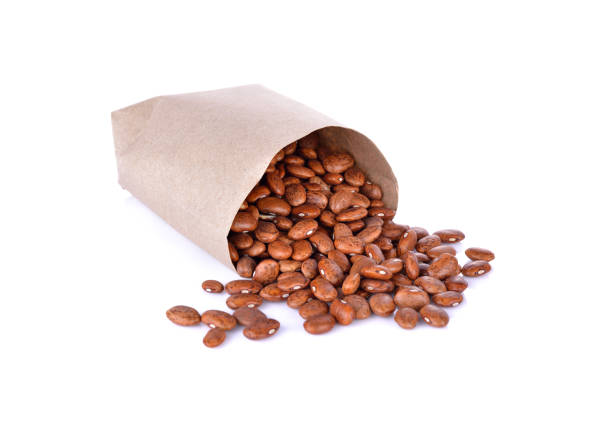 istock uncooked pinto beans in paper bag and on white background 680337910