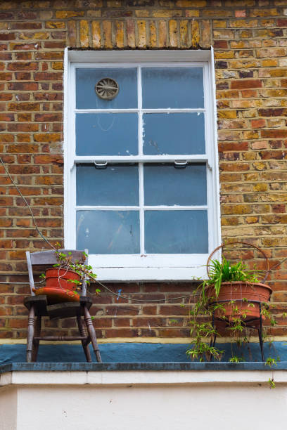 istock window with chair and flower pots 680338634