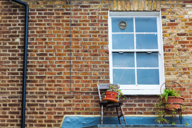 istock window with chair and flower pots 680338666