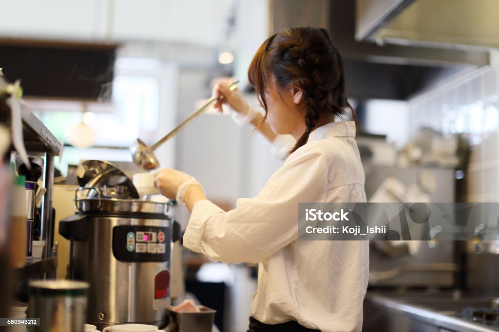 The salesclerk who pours soup a clerk pouring soup Retail Clerk Stock Photo