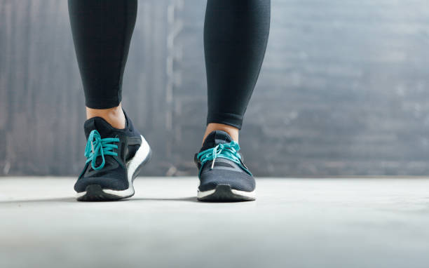 istock Female runner tying her shoes preparing for a run 680346280
