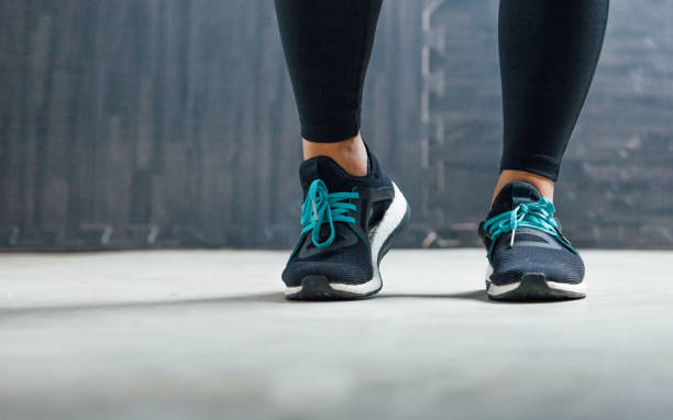 istock Female runner tying her shoes preparing for a run 680346374