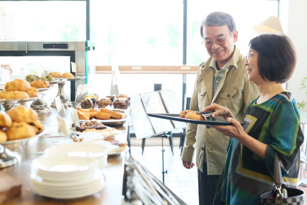 istock Elderly couple shopping at a cafe 680346476