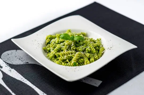 Basil pesto pasta salad. Rotini pasta with basil pesto sauce, grated parmesan cheese and fresh pepper. This Italian dish makes a delicious meal by itself or can be used as a pasta salad side.
