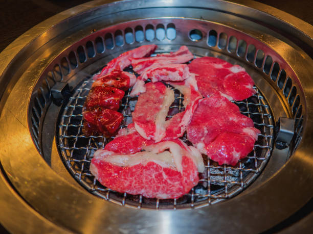 istock Sliced beef on hot charcoal grill, yakiniku restaurant. 680349658