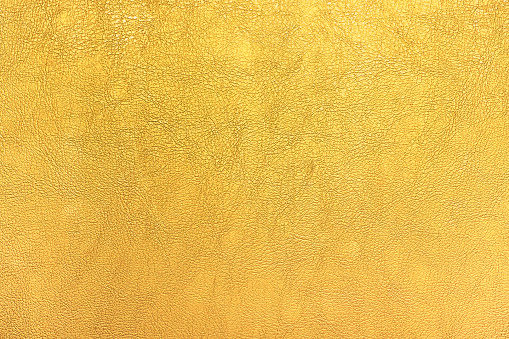 Bright gold color leather texture background.