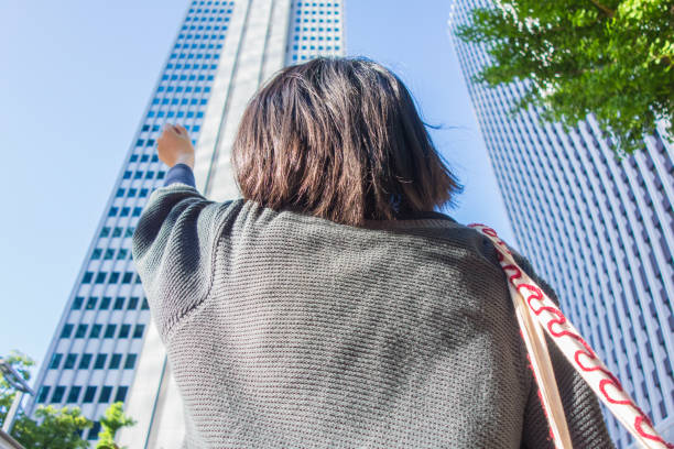 istock Woman looking at office buildings 680358908