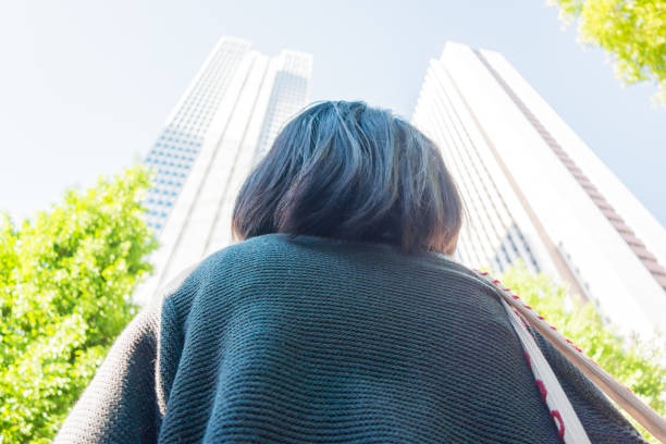 istock Woman looking at office buildings 680358932