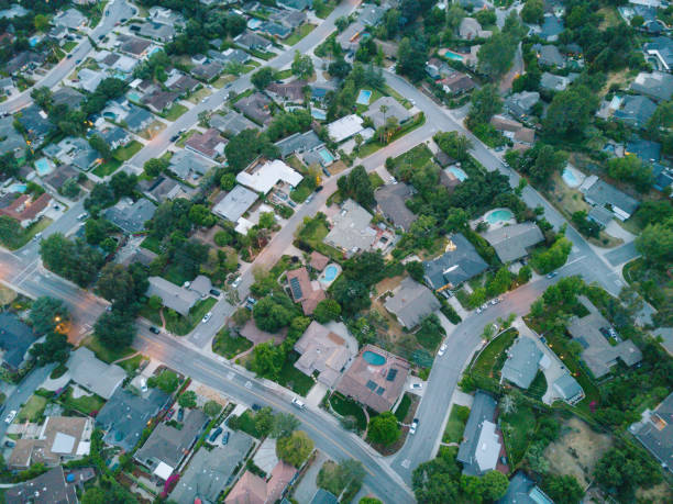 Aerial of Neighborhood An aerial shot of a neighborhood next to the mountains. autumn field tree mountain stock pictures, royalty-free photos & images