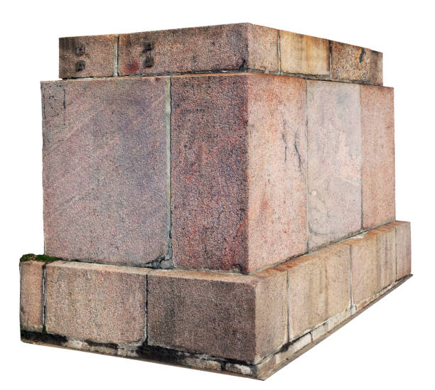 The base for a old statue or a column is made of roughly processed granite aged blocks. Isolated on white