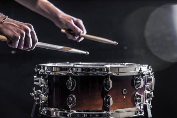 istock man plays musical percussion instrument with sticks, a musical concept, beautiful lighting on the stage 680368196