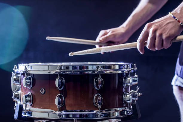 istock man plays musical percussion instrument with sticks, a musical concept, beautiful lighting on the stage 680368234
