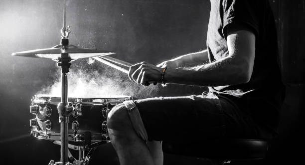istock man plays musical percussion instrument with sticks, a musical concept, beautiful lighting on the stage 680368348