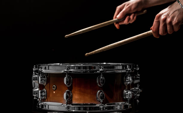istock man plays musical percussion instrument with sticks a musical concept with the working drum 680368350