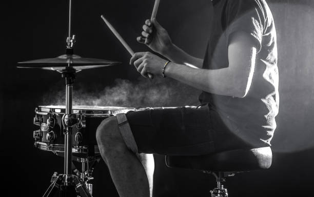 istock man plays musical percussion instrument with sticks, a musical concept, beautiful lighting on the stage 680368352