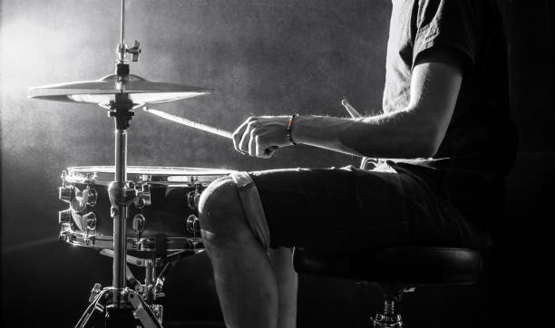 istock man plays musical percussion instrument with sticks, a musical concept, beautiful lighting on the stage 680368384