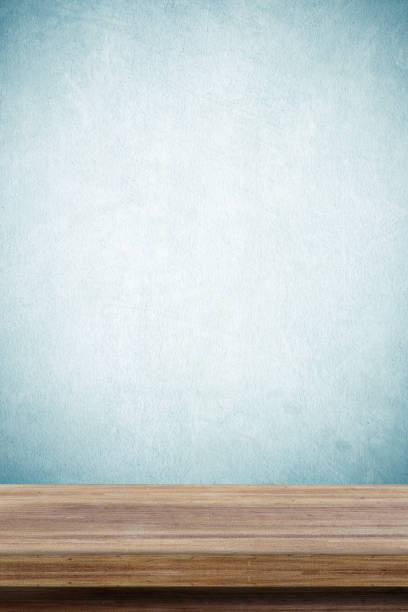 istock Empty wooden table over green cement wall  background, for product display montage 680374036