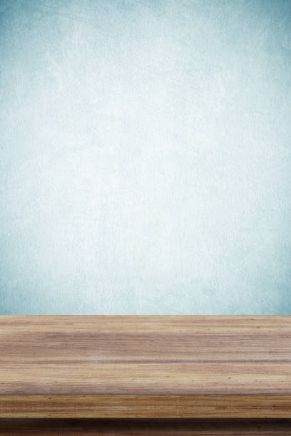 istock Empty wooden table over green cement wall  background, for product display montage 680374130