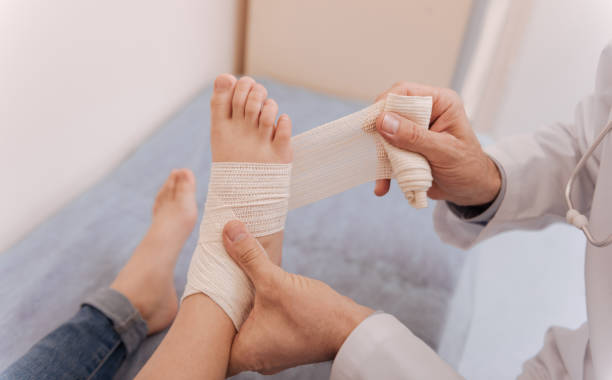 istock Skillful careful doctor applying bondage for fixation 680374152