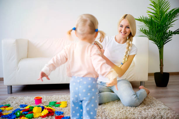 istock Mother playing with her baby daughter 680374548