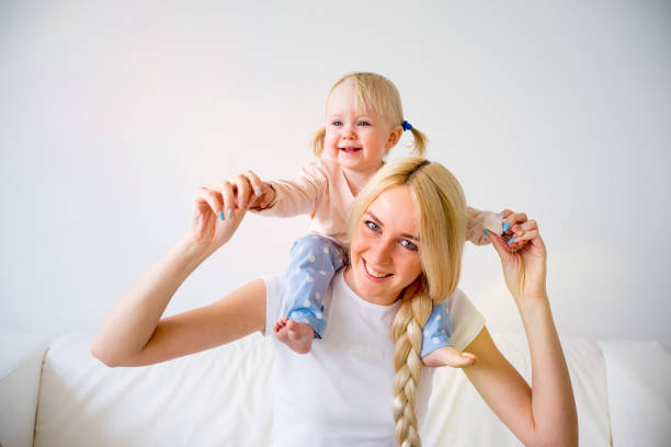 istock Mother playing with her baby daughter 680374670