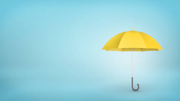 istock An open classic yellow umbrella with a handle vertically placed on blue background 680375014