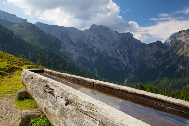 istock Rural scenery with wooden water well 680384736