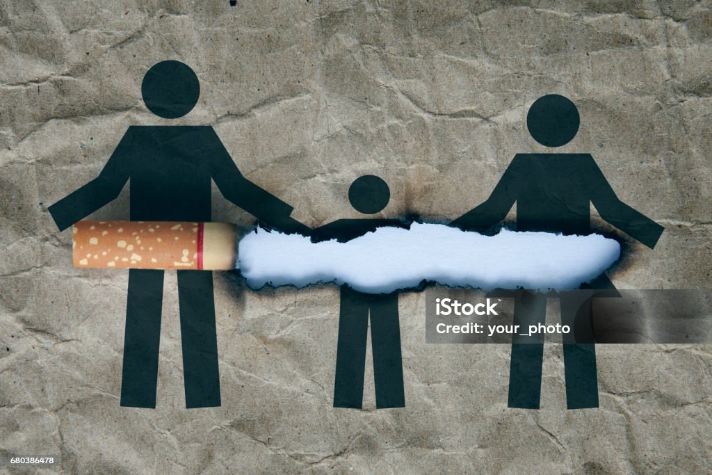 stop smoking concept Cigarette burning brown paper with family-shaped.Concept quit,stop smoking and world no tobacco day Active Seniors Stock Photo