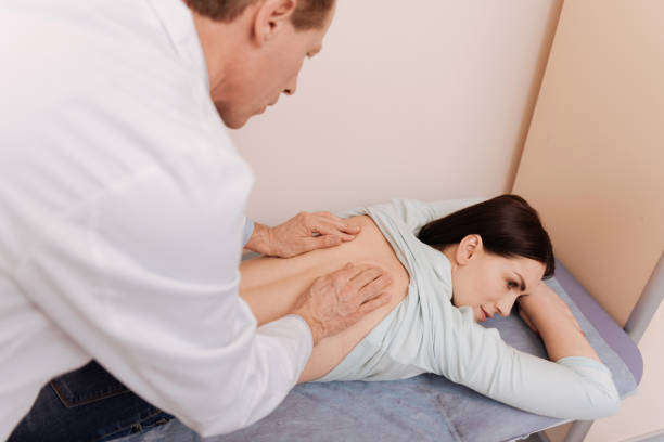 istock Great qualified specialist helping lady minifying the pain 680386714