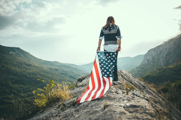 istock Woman patriot with US flag 680387228