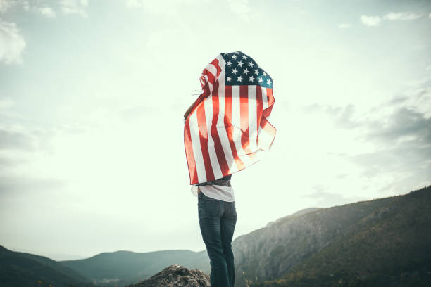 istock Girl with US flag on mountain 680387438