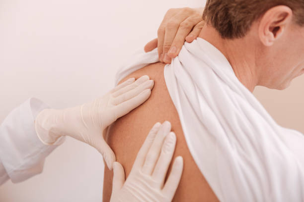 istock Helpful nice patient holding his shirt up 680387474