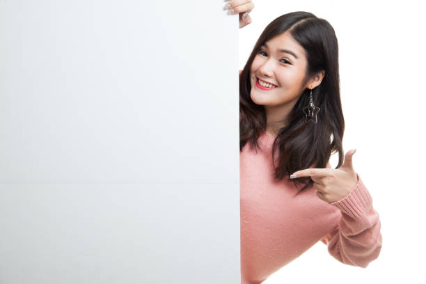 istock Young Asian woman point to a  blank sign. 680393036