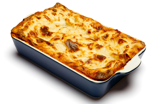 Lasagna in baking dish isolated on white bacground