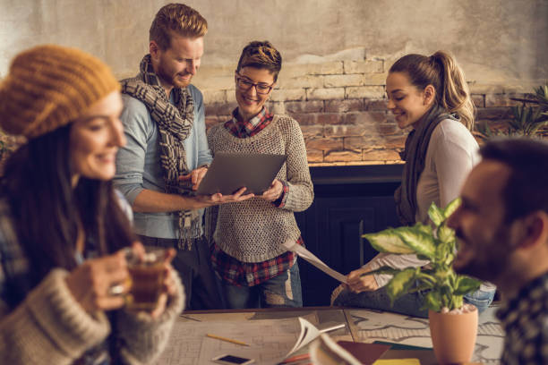 istock Group of smiling freelancers working at casual office. 680407892