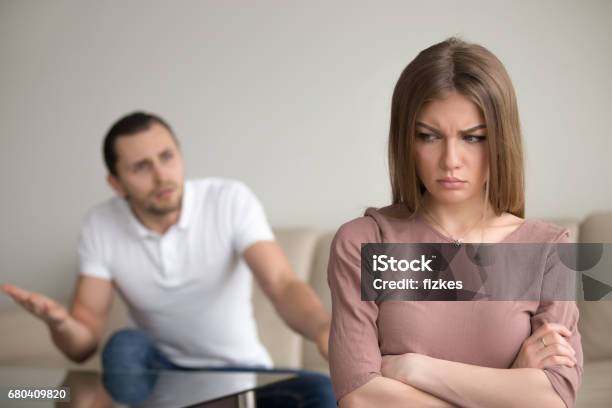 Angry Husband Mad At Wife Unhappy Woman Frustrated Family Conflict Stock Photo - Download Image Now