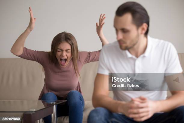 Young Couple Quarrelling Hysterical Wife Screaming At Husband Drama Queen Stock Photo - Download Image Now