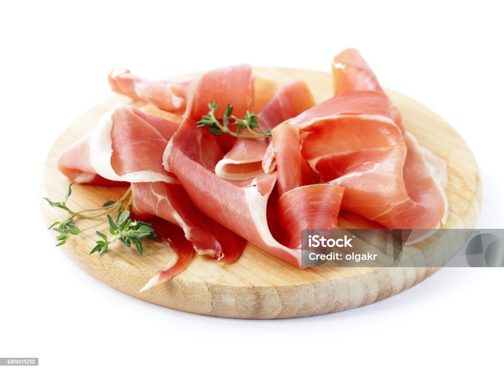 Smoked Parma ham on a wooden board Prosciutto Stock Photo