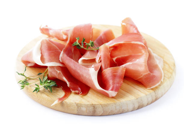 Smoked Parma ham on a wooden board Smoked Parma ham on a wooden board prosciutto stock pictures, royalty-free photos & images