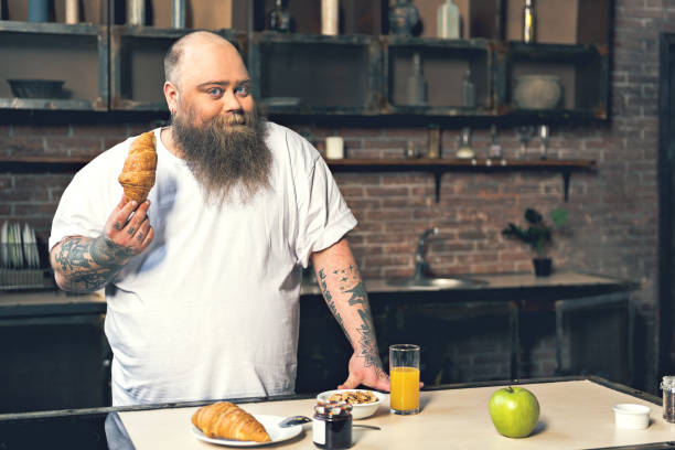 istock Happy thick guy having breakfast at home 680411860