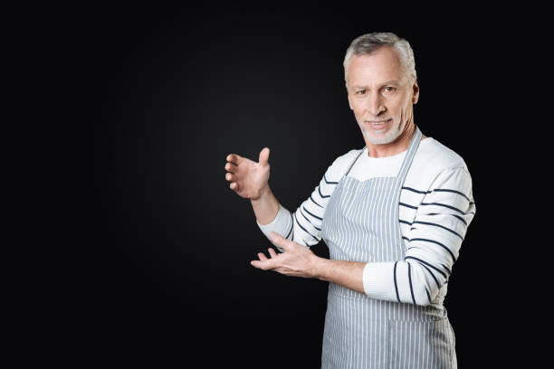 personnes âgées handsome man holding mains dans l’air - looking at camera facial expression gesturing touching photos et images de collection