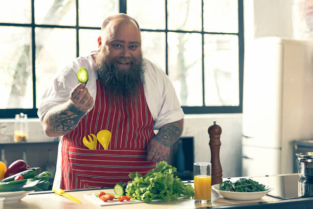 istock Joyful thick guy enjoying healthy food preparation 680413478
