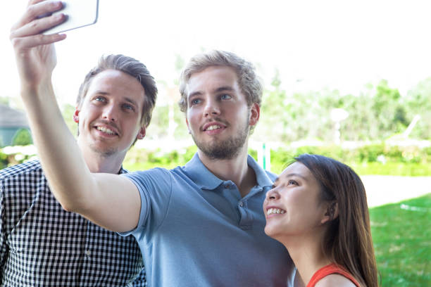 istock Positive young friends taking selfie in park 680415762