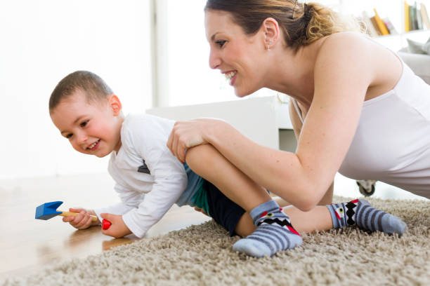 istock Beautiful young mother and her son having fun at home. 680424404