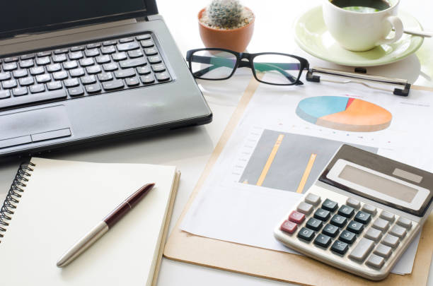 istock Accessories work laptop on the table, chart, calculator, pen. 680424550