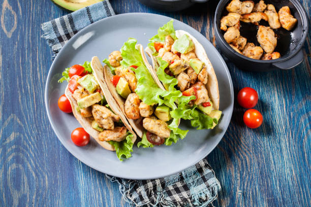 Authentic mexican tacos with chicken and salsa with avocado, tomatoes and chillies stock photo