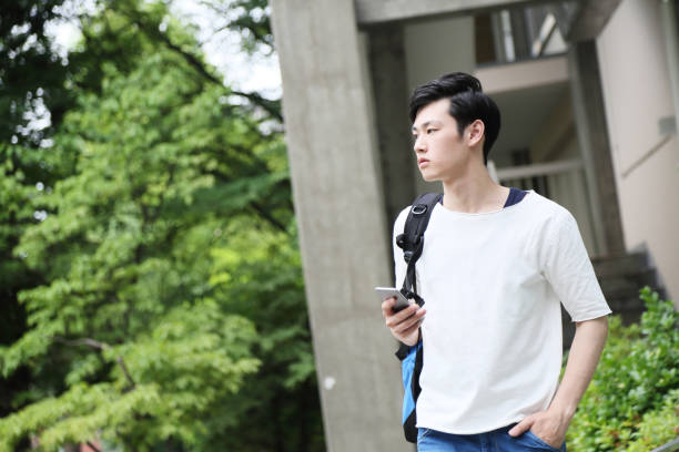 istock The student waiting for a friend operates a smartphone 680428356