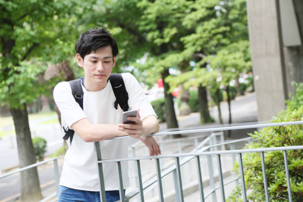 istock The student waiting for a friend operates a smartphone 680428404