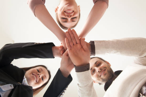 istock Successful united business team put hands together, view from below 680437294